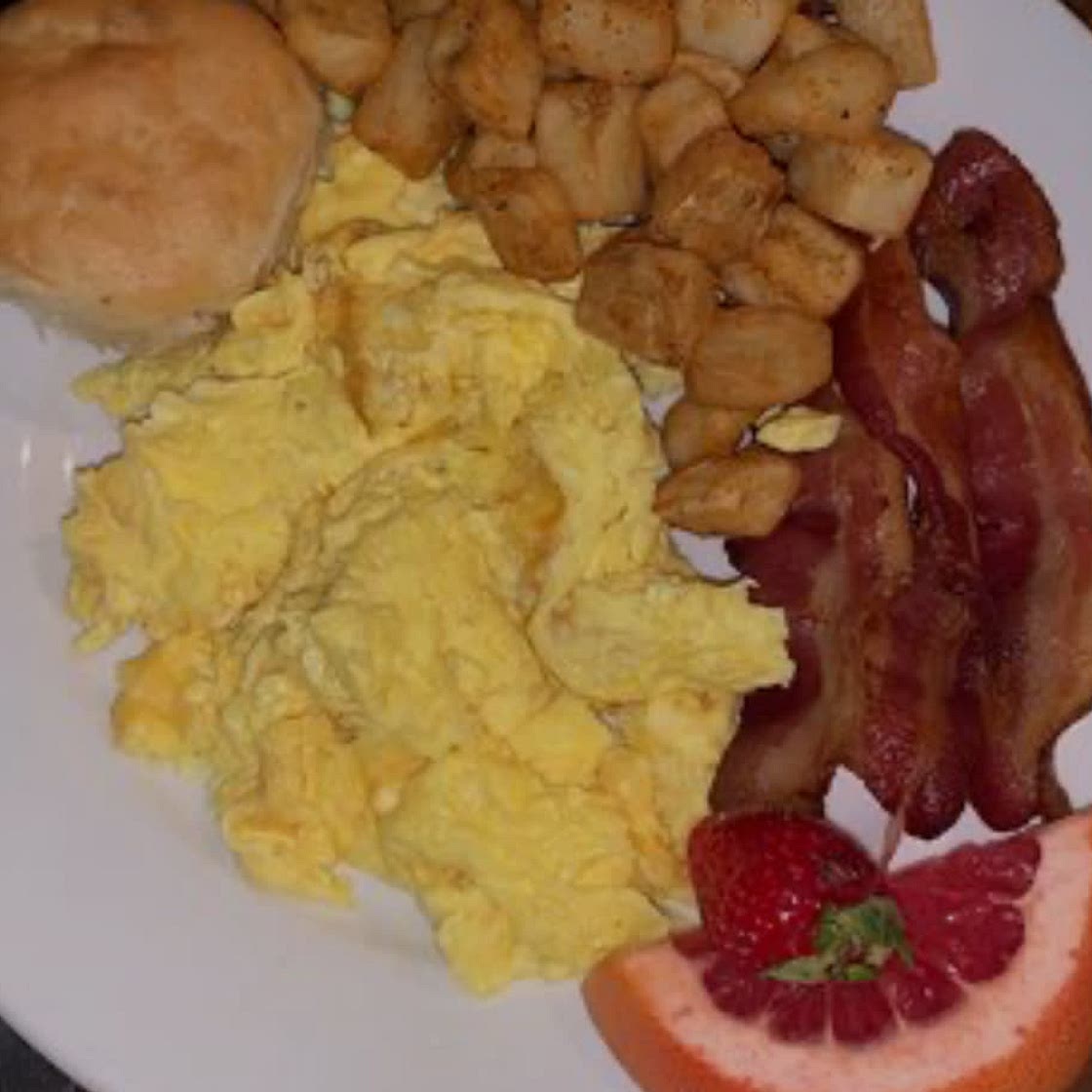 Eggs, bacon, fried potatoes, and biscuits