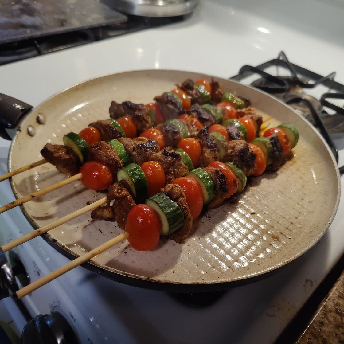 Spiced lamb kebabs with pea & herb couscous