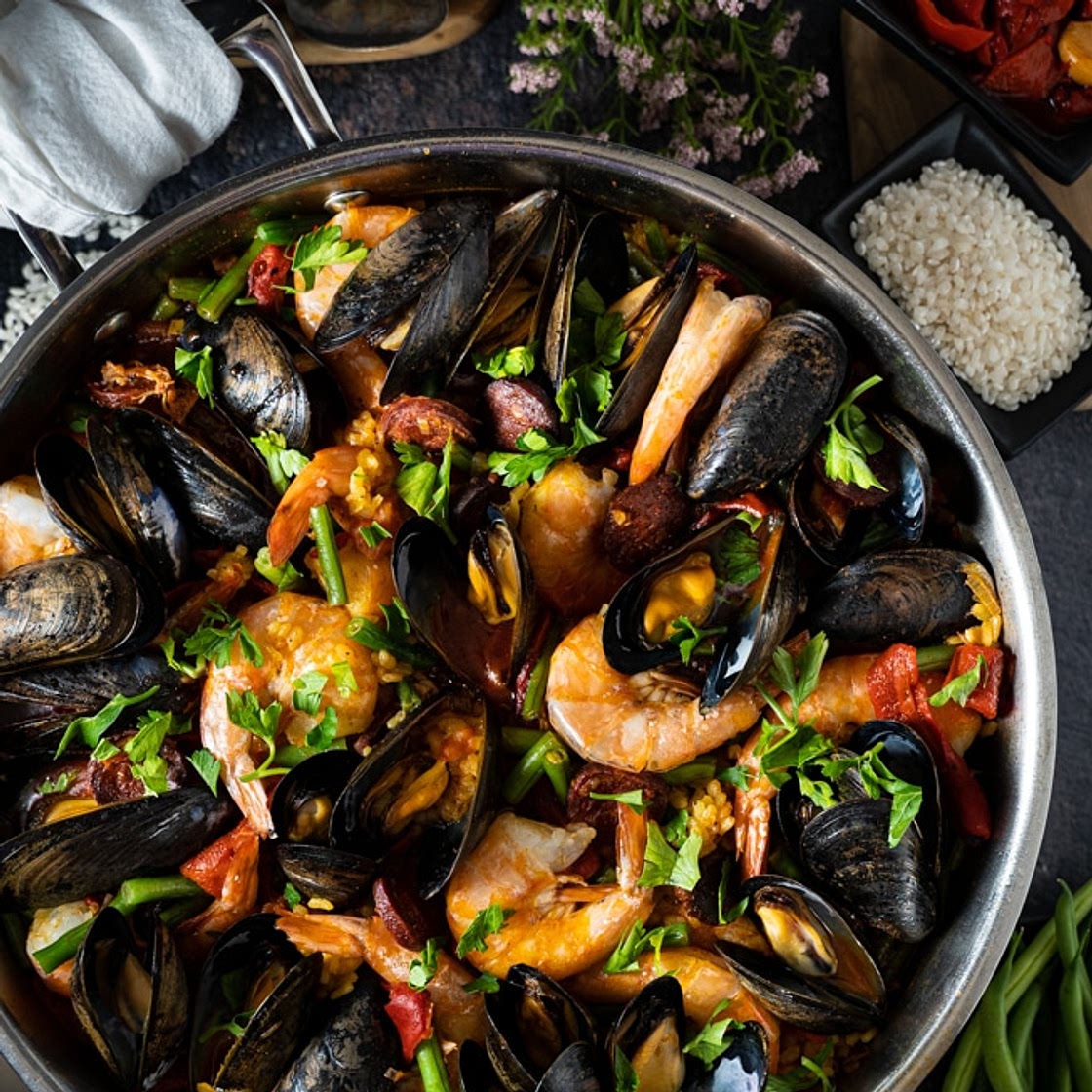 Paella with chicken, chorizo and seafood