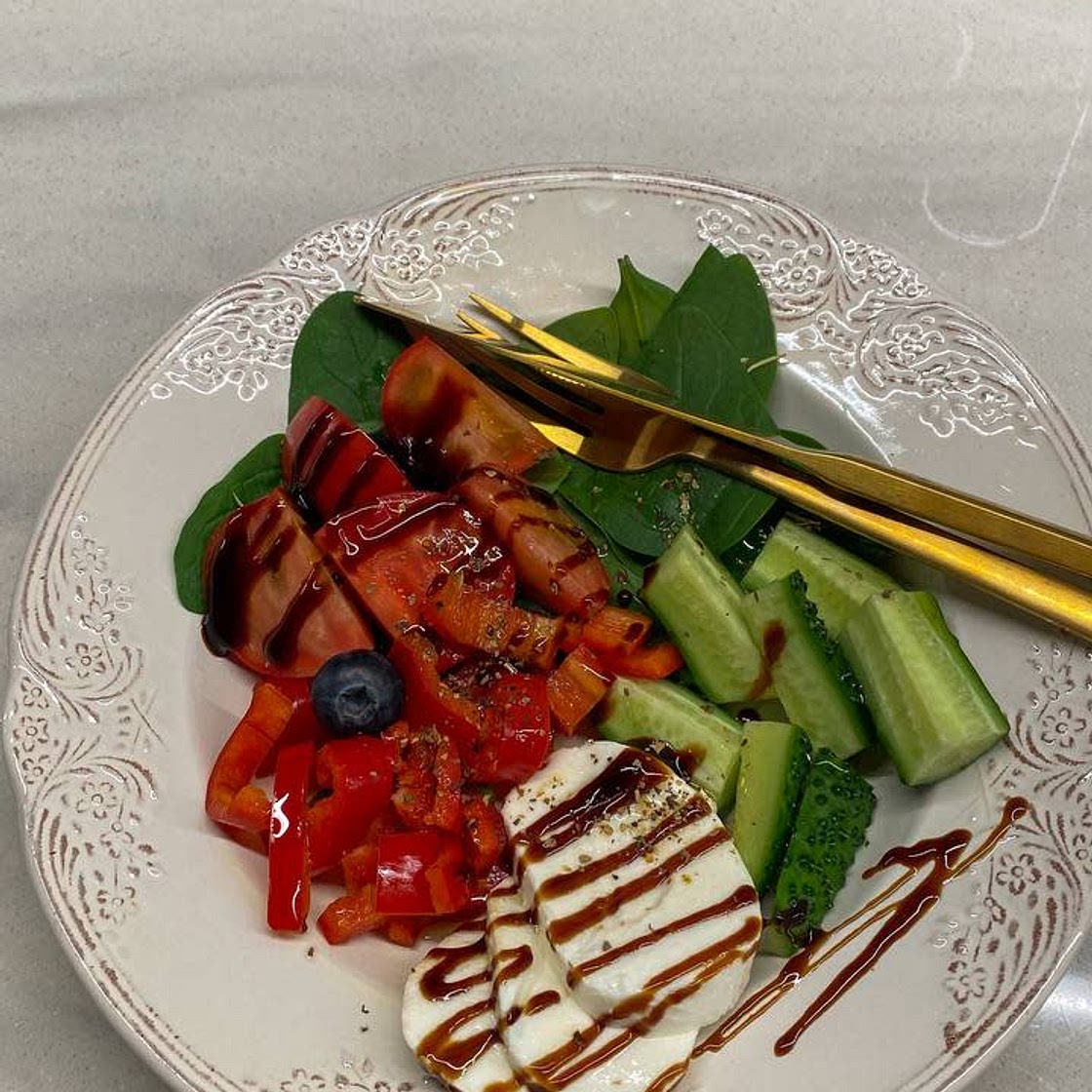 simple salad with cucumber, pepper, tomatoes and cheese