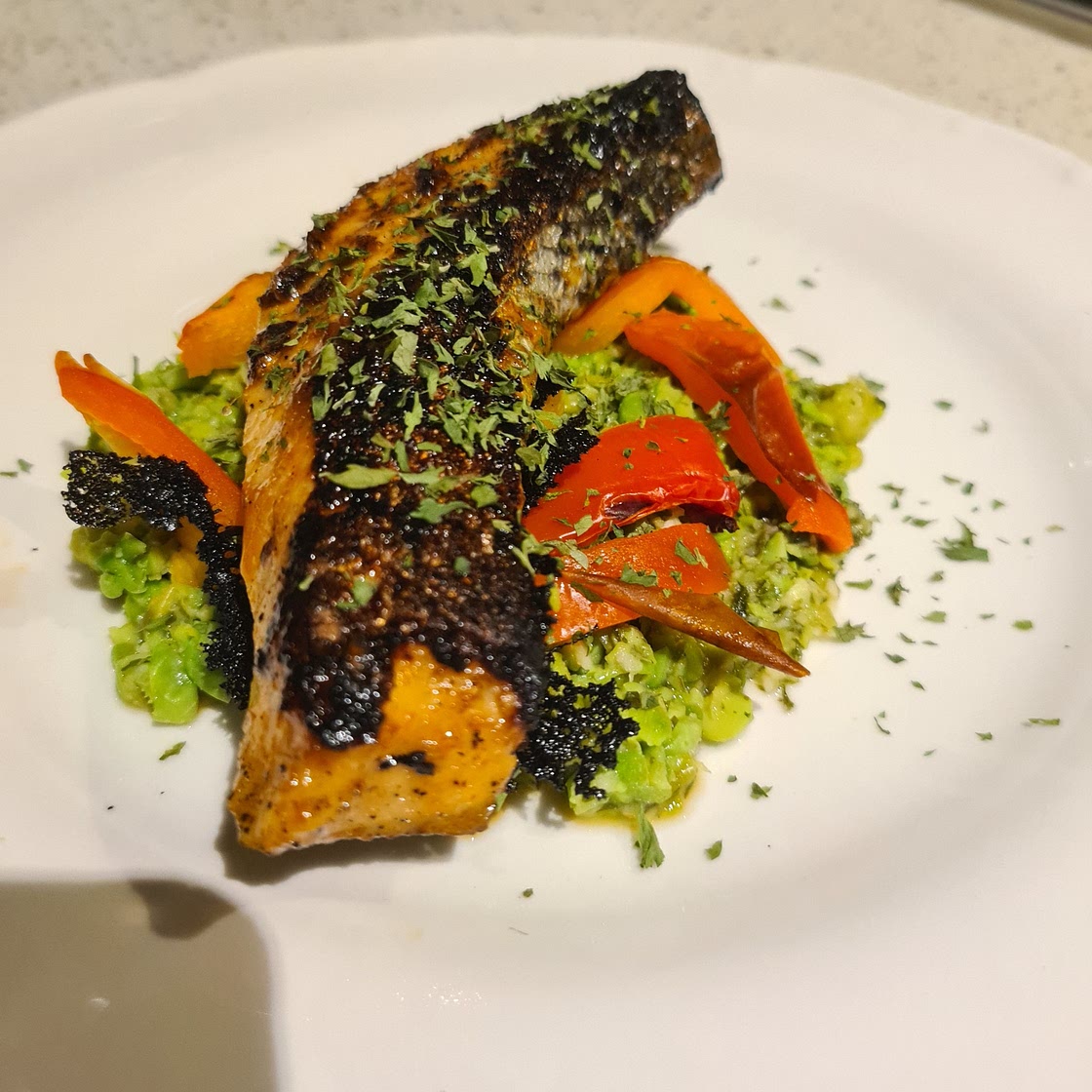 Firecracker Salmon with pea mash and roasted capsicum
