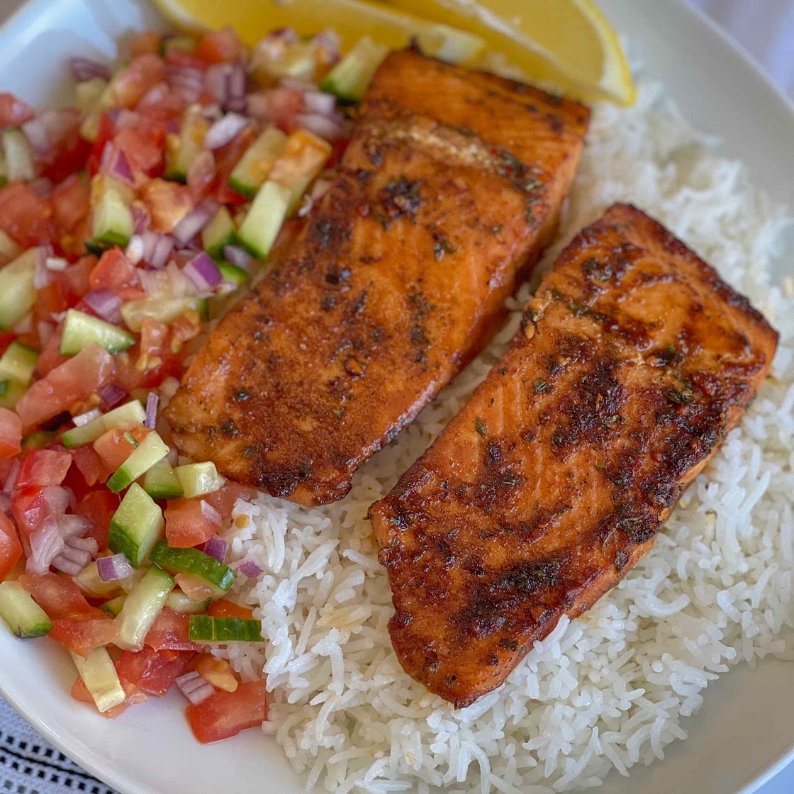 Salmon served with rice and a simple salad 