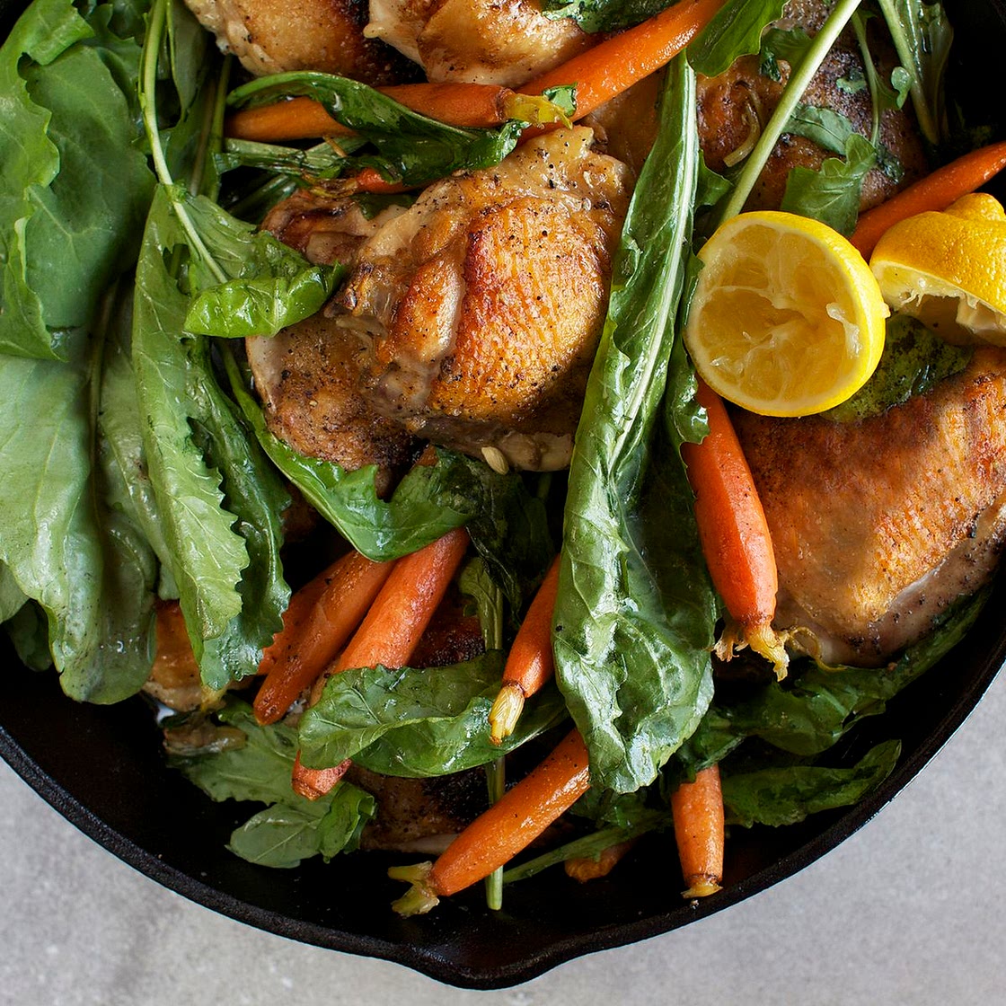 Skillet-Roasted Chicken Thighs With Dandelion Greens & Baby Carrots