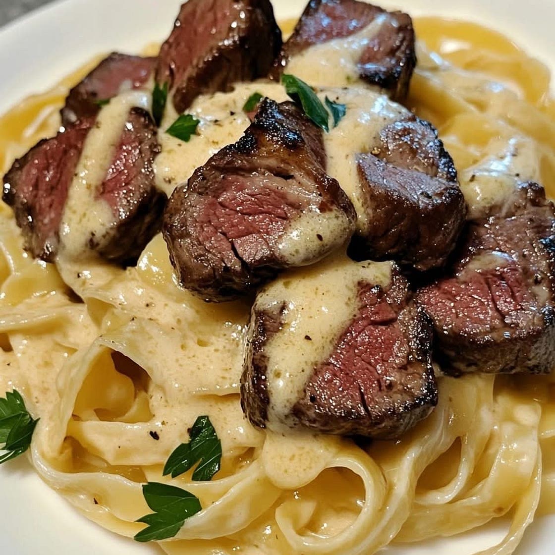 Steak bites in fettuccine garlic butter sauce