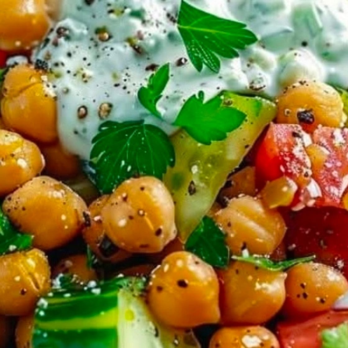 Chickpea Greek Salad topped with homemade Tzatziki
