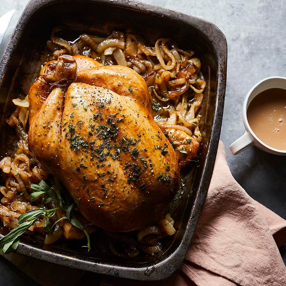 Roast chicken with tarragon butter and melting onions