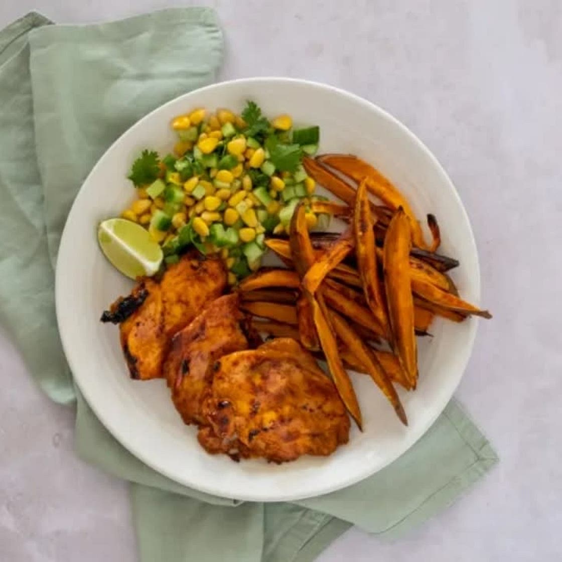Sweet potato air fryer chips with seasoned chicken breast and peas