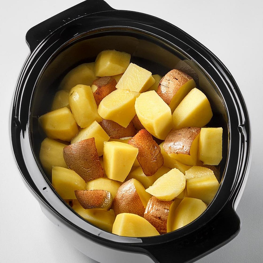 Put raw cubed russet potatoes in a slow cooker with these 3 ingredients. A cozy treat for winter nights
