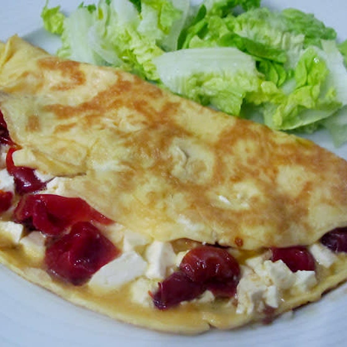 Tortilla con tomates secos, espinacas y queso feta