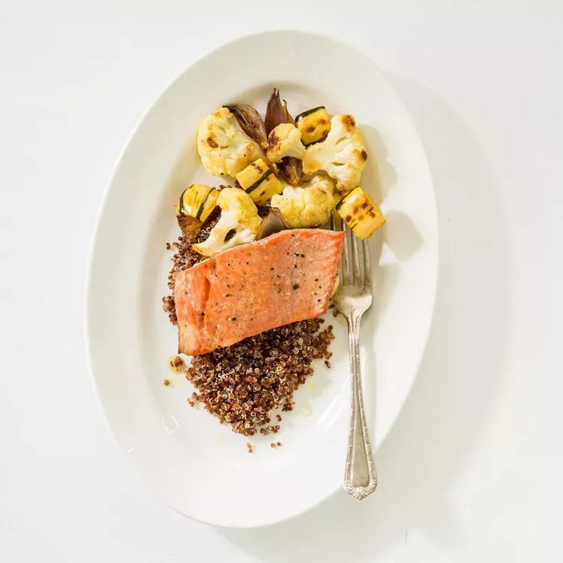 Baked Salmon with side of Roasted Cauliflower and Brussel Sprouts served on Quinoa