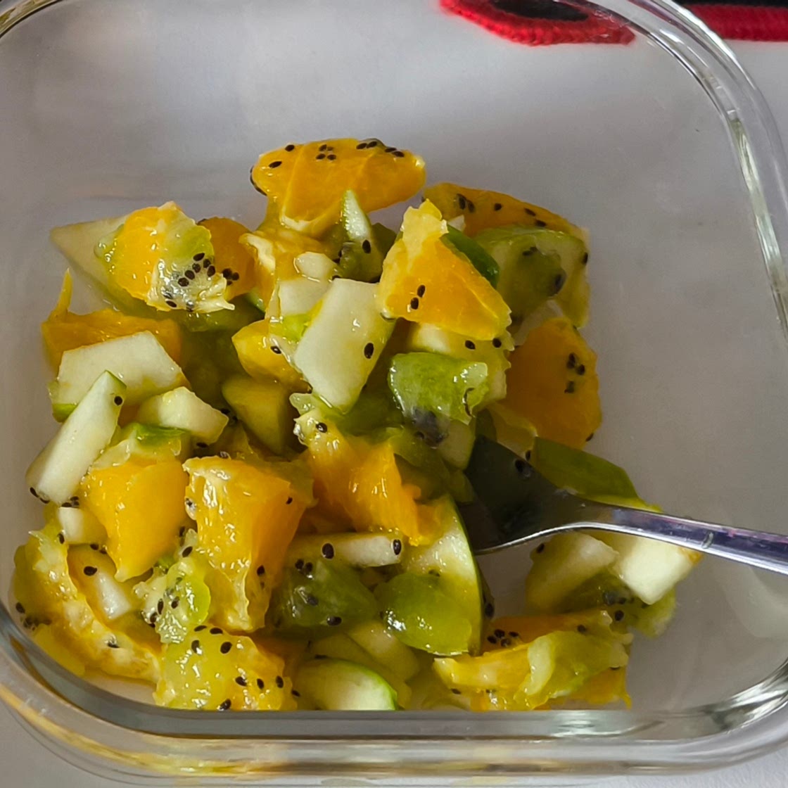 Fruit salad with kiwi, orange, and apples