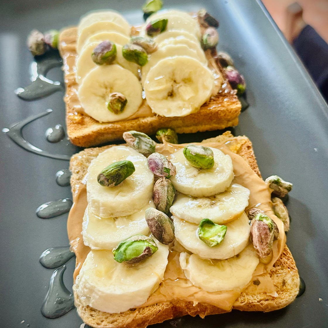 Toasted Whole Grain Bread with Cashew Butter, Air-Fried Banana, Agave Syrup & Pistachios