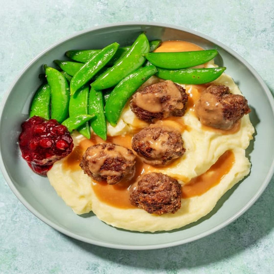 Swedish-Style Beef Meatballs with Creamy Gravy and Buttery Snap Peas