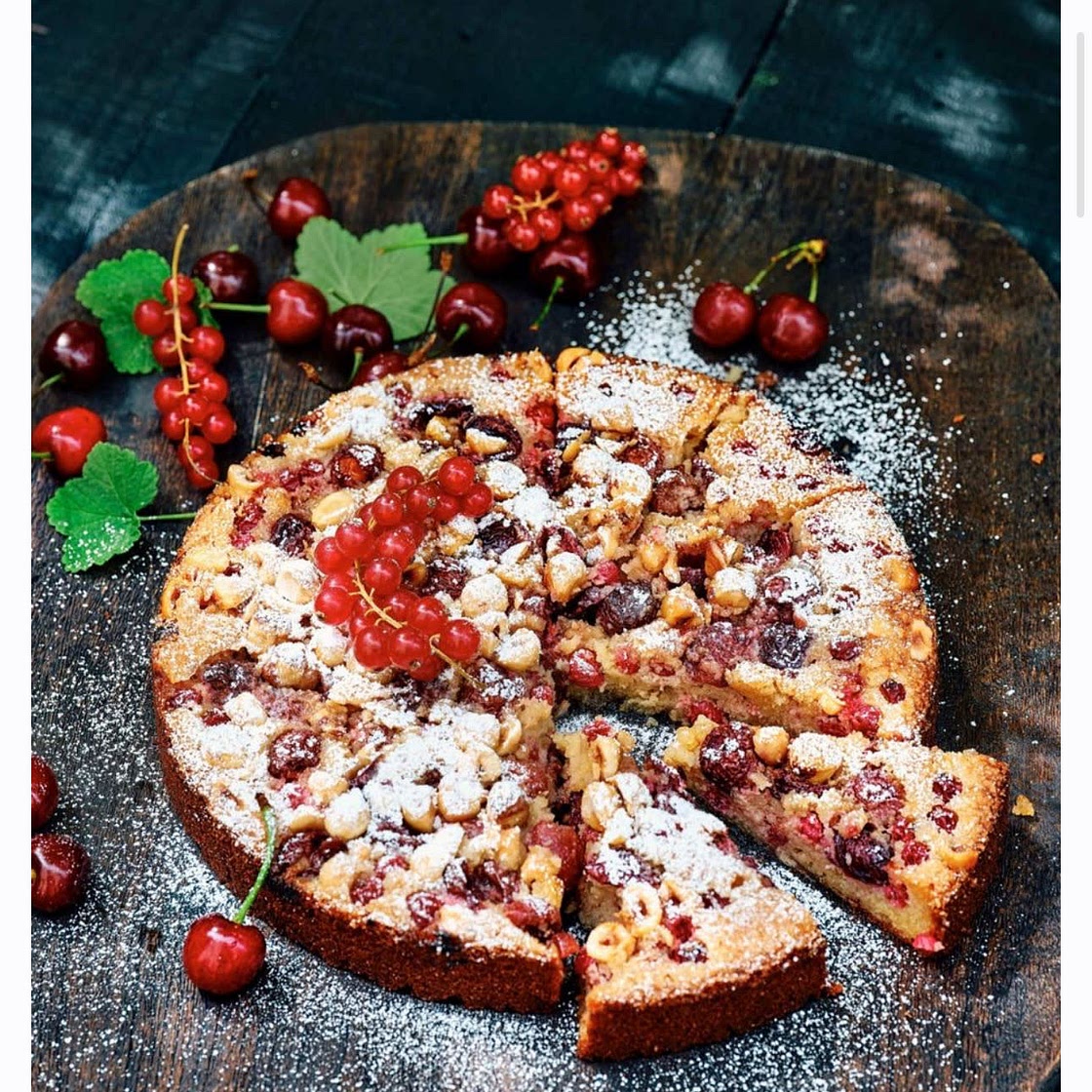 Quick almond paste cake with red berries and hazelnuts