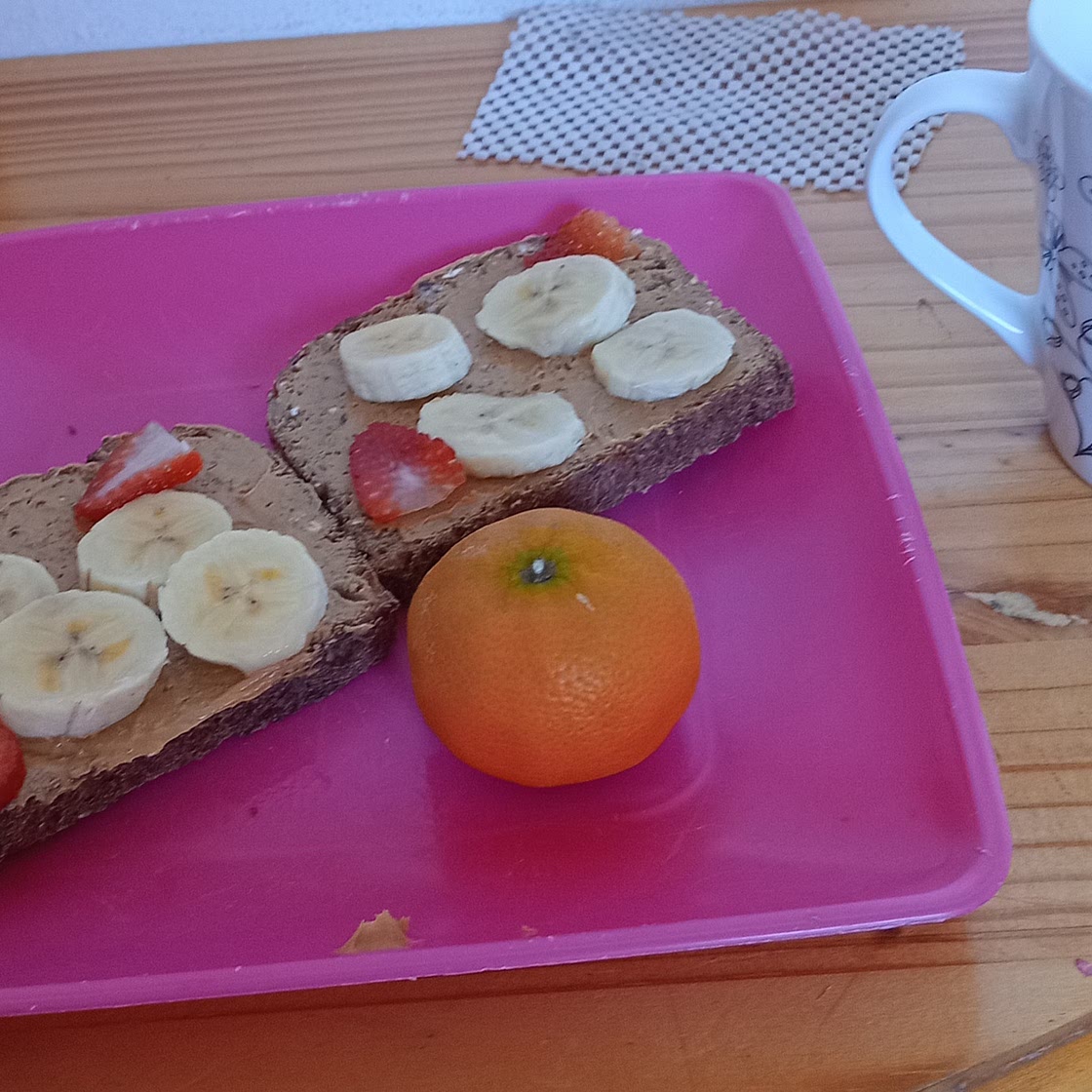 Peanut butter toast with banana and strawberries