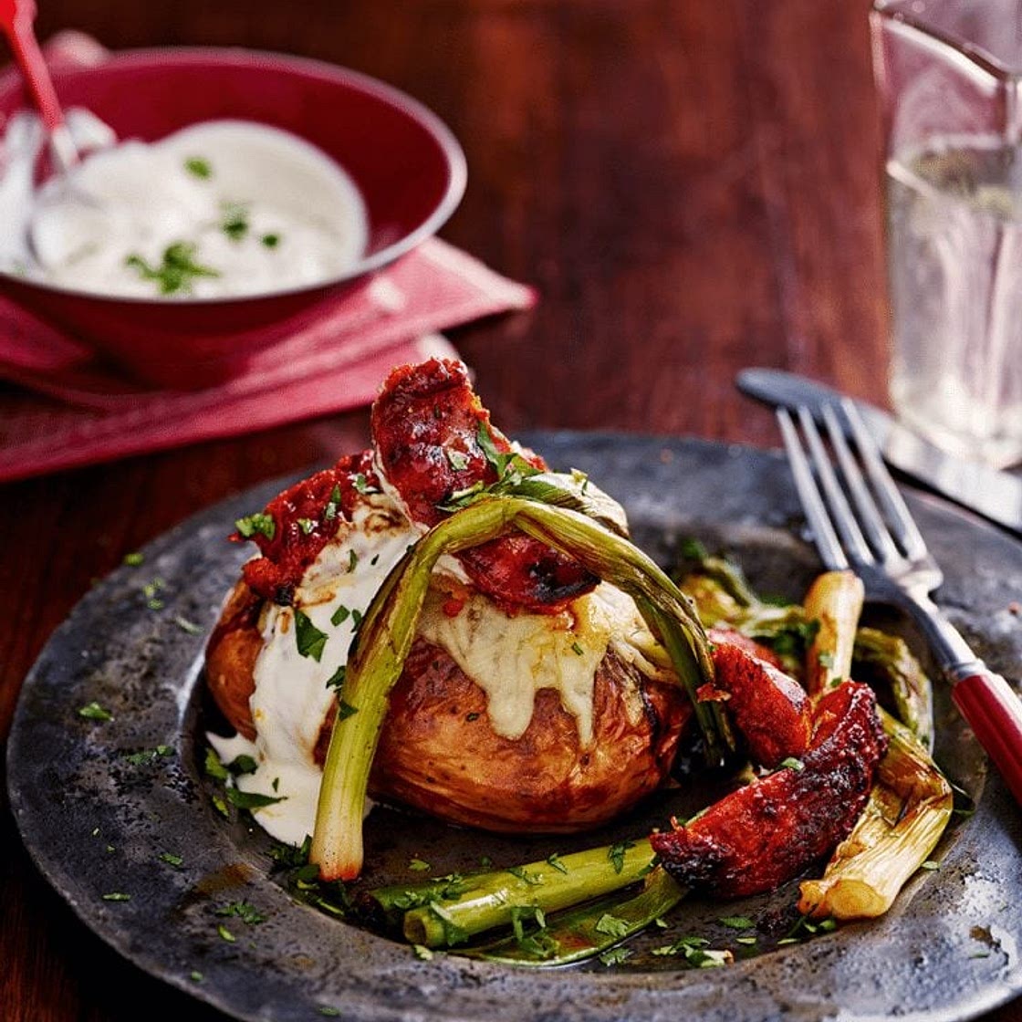 Crisp-skinned jackets with cheese, chorizo and spring onions