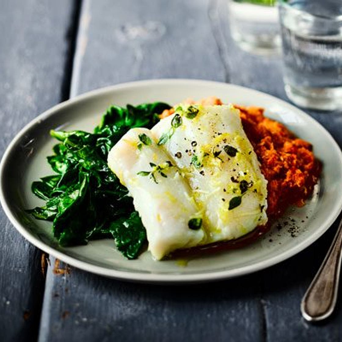 Herb & garlic baked cod with romesco sauce & spinach