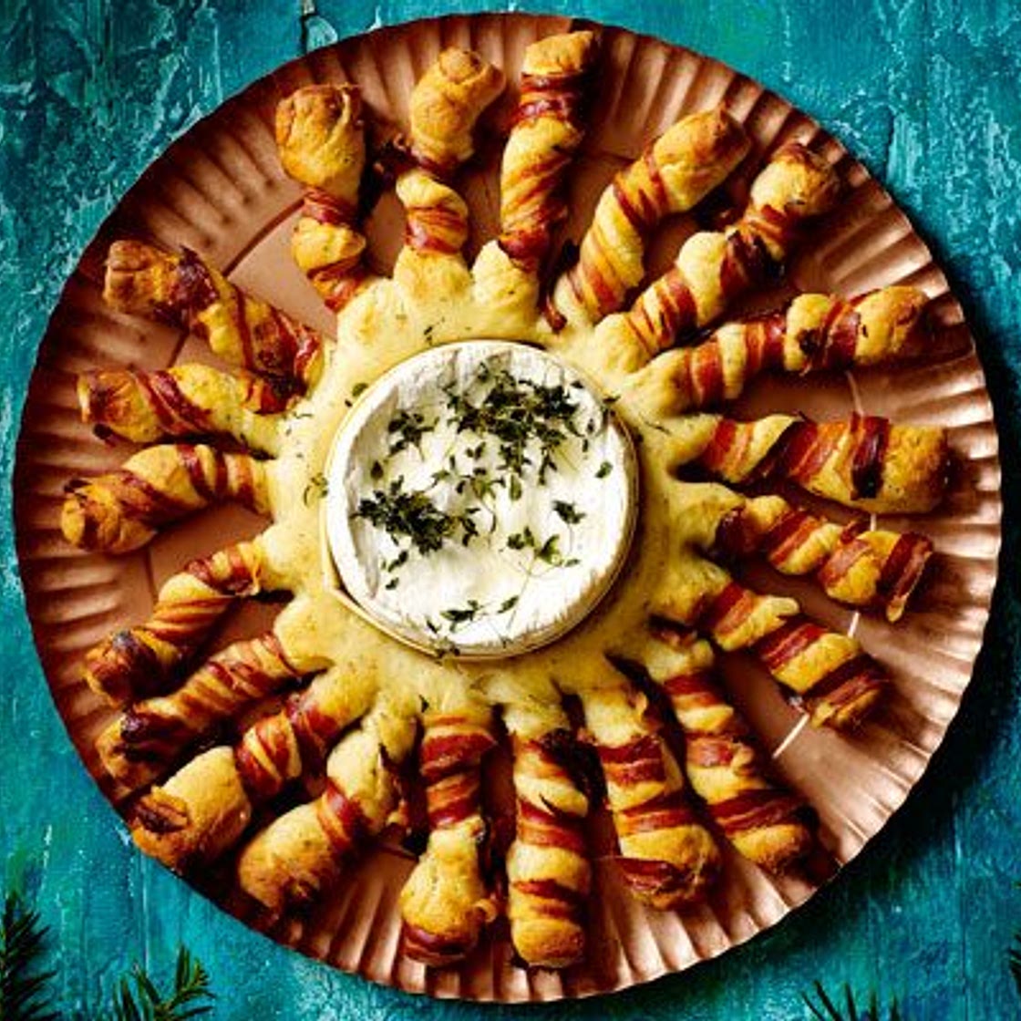 Baked camembert with bacon-wrapped breadsticks