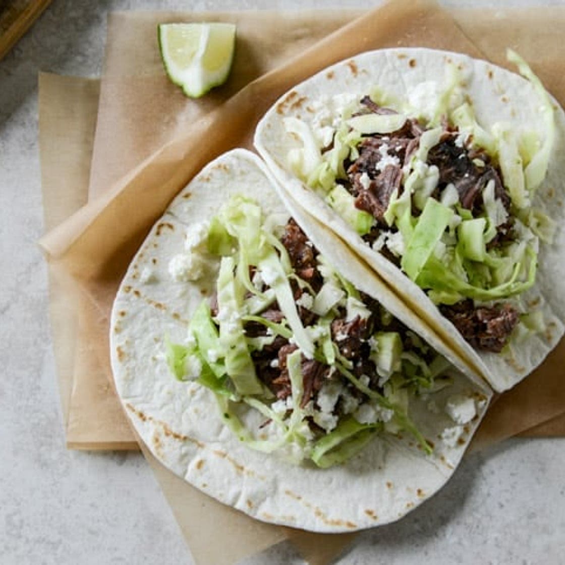 Crockpot Short Rib Tacos with Salted Lime Cabbage and Queso Fresco
