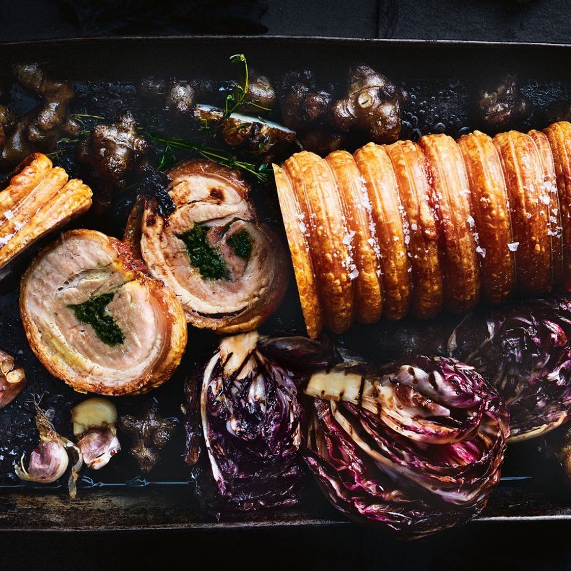 Herb and garlic porchetta with roast winter vegetables