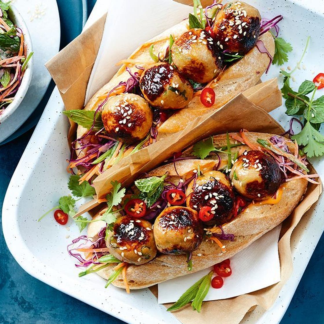 Honey-glazed miso chicken meatball subs with rainbow slaw