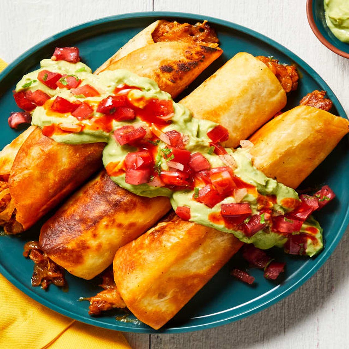 Fully Loaded Pork Taquitos with Pico de Gallo, Creamy Guacamole & Hot Sauce