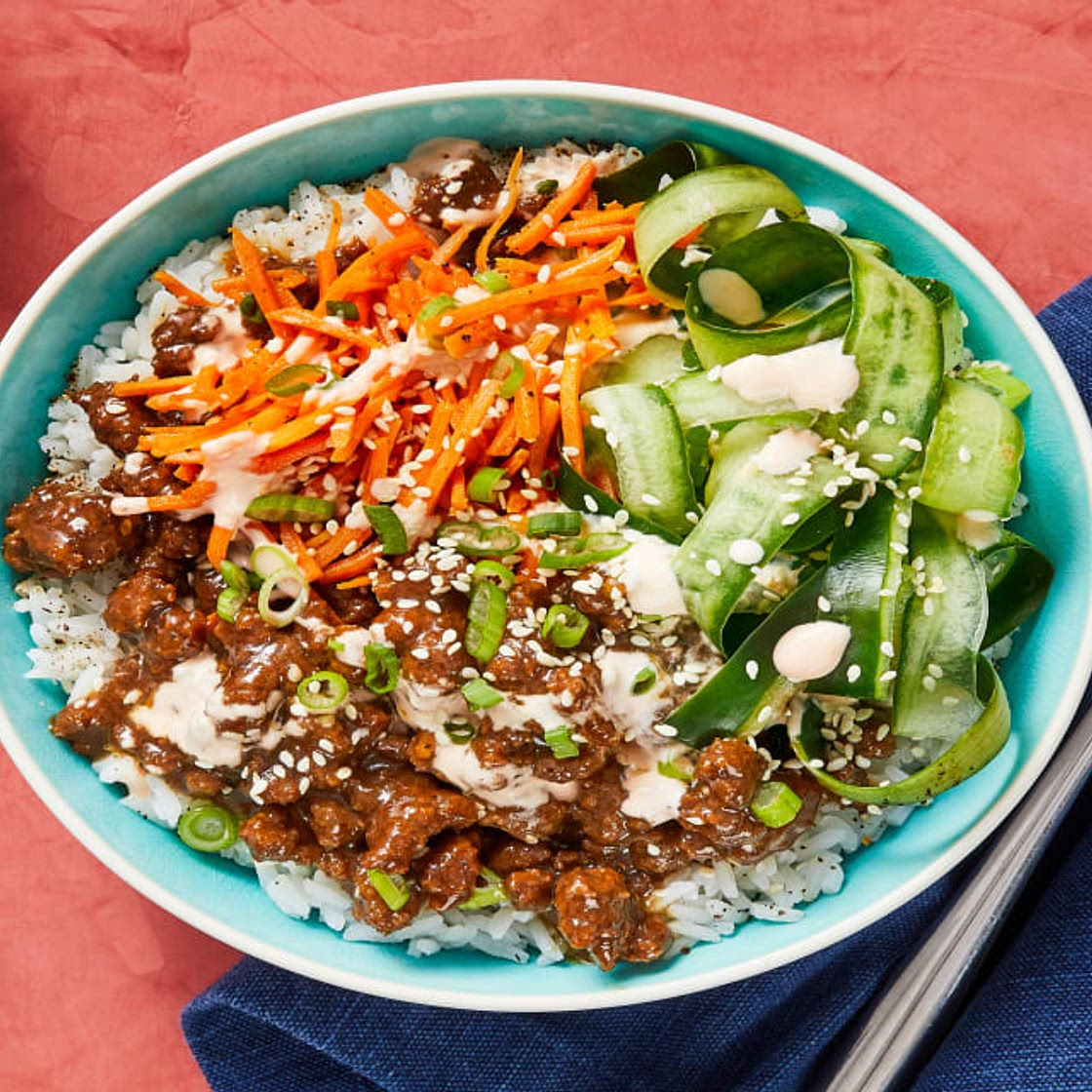 Beef Bulgogi Bowls with Carrots, Pickled Cucumber & Sriracha Crema over Jasmine Rice
