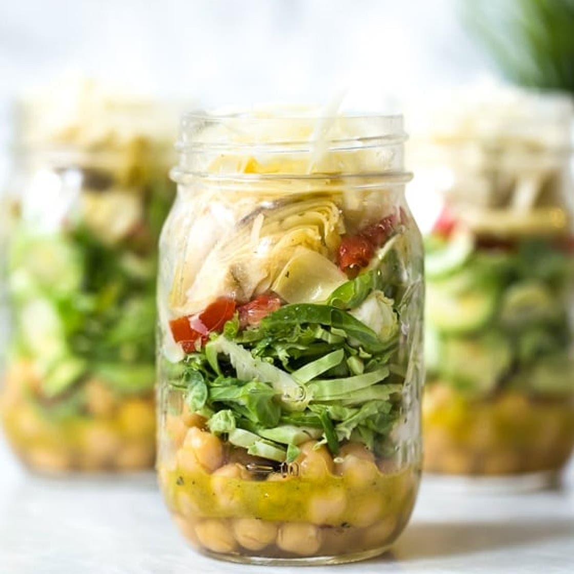 Raw Brussels Sprouts and Chickpea Salad in a Jar with Artichokes, Sun Dried Tomatoes and Asiago