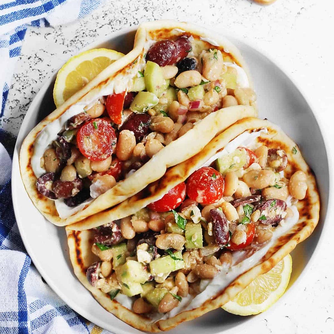 Greek salad wraps with white beans and garlic yogurt