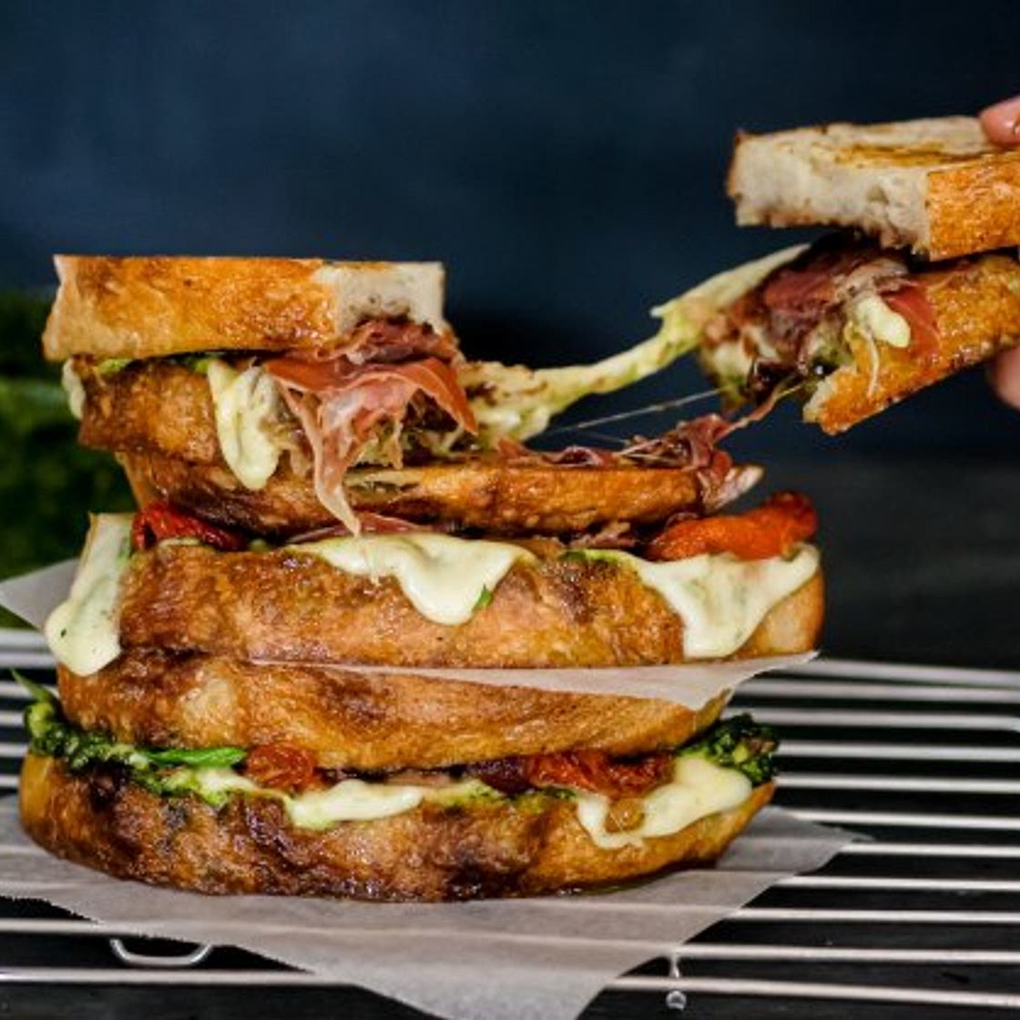 Loaded caprese toasties with pesto, onion jam and serrano ham
