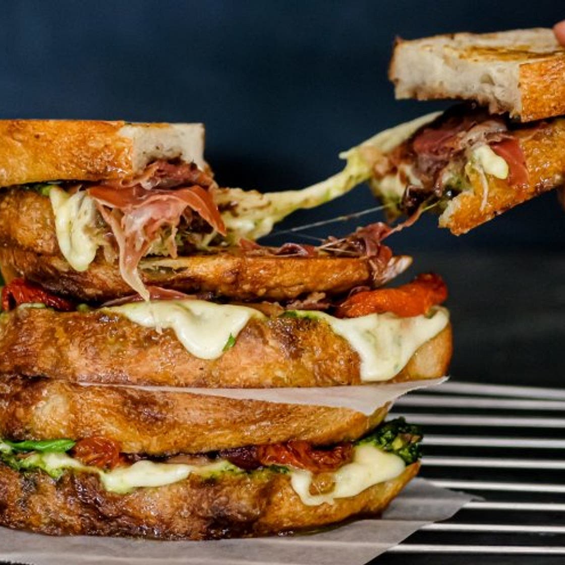 Loaded caprese toasties with pesto, onion jam and serrano ham