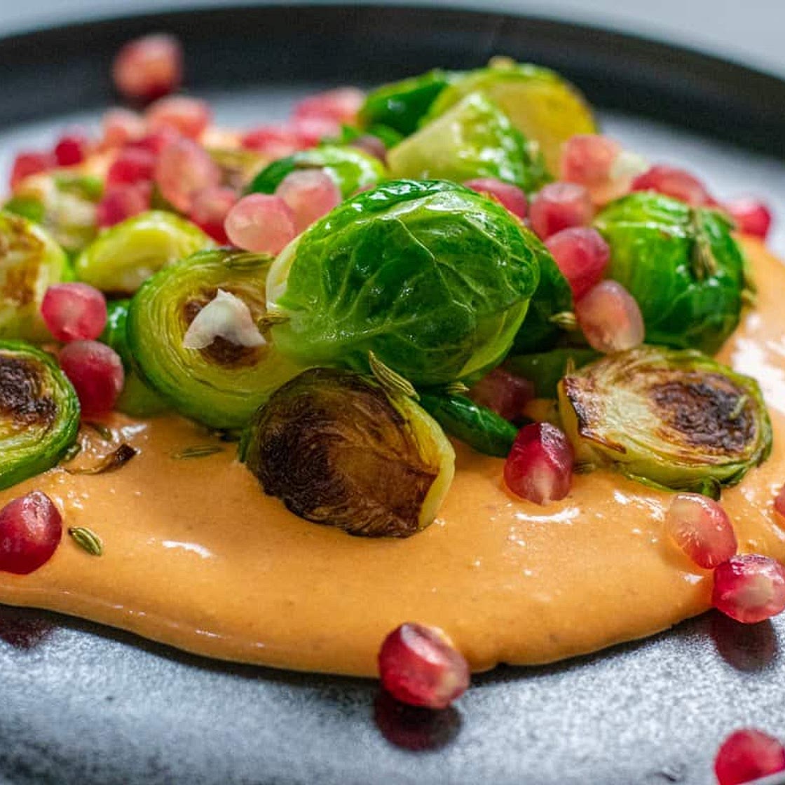 Caramelised Brussels sprouts with whipped harissa feta, fennel and pomegranate seeds