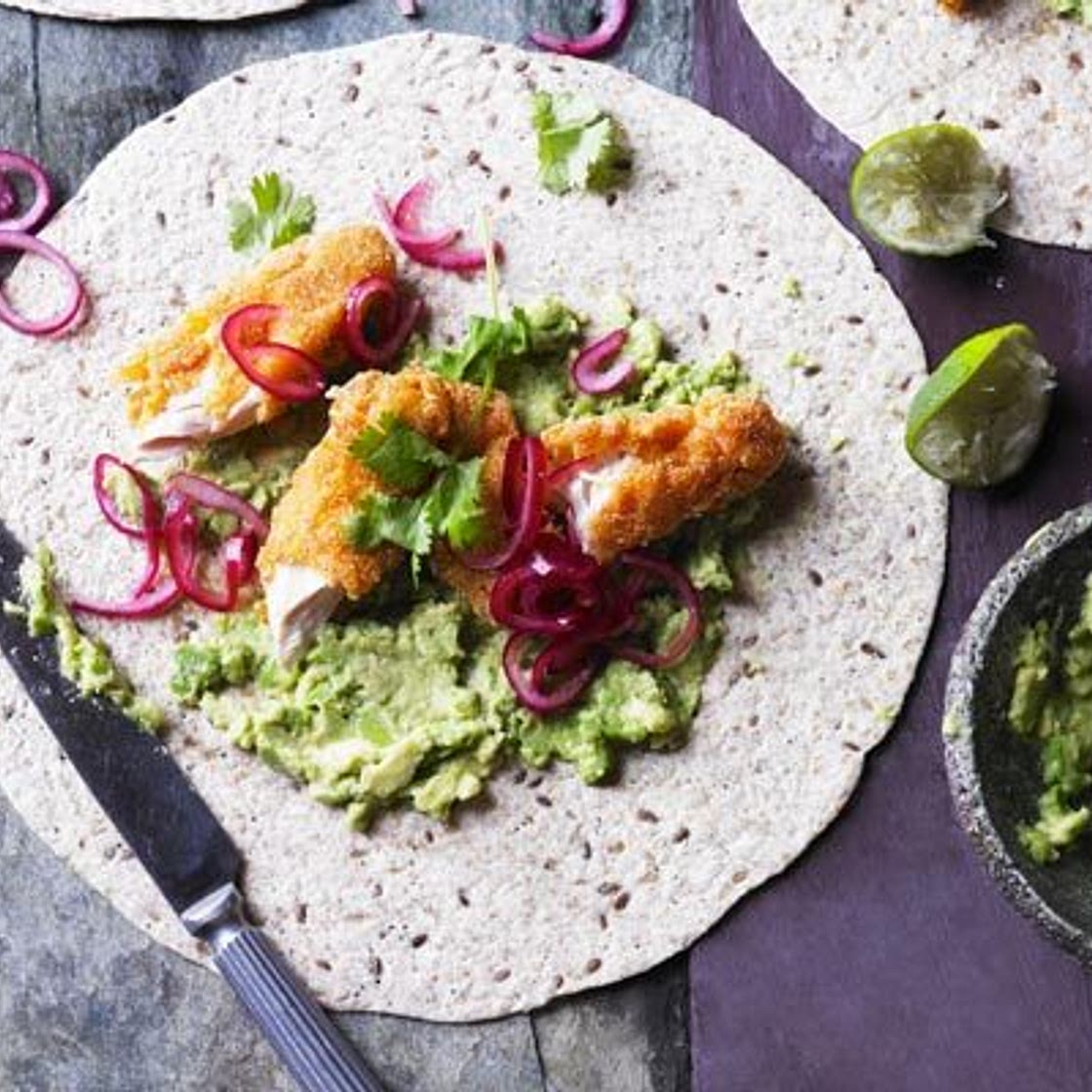 Smashed avocado with crispy chicken, pickled onions & tortillas