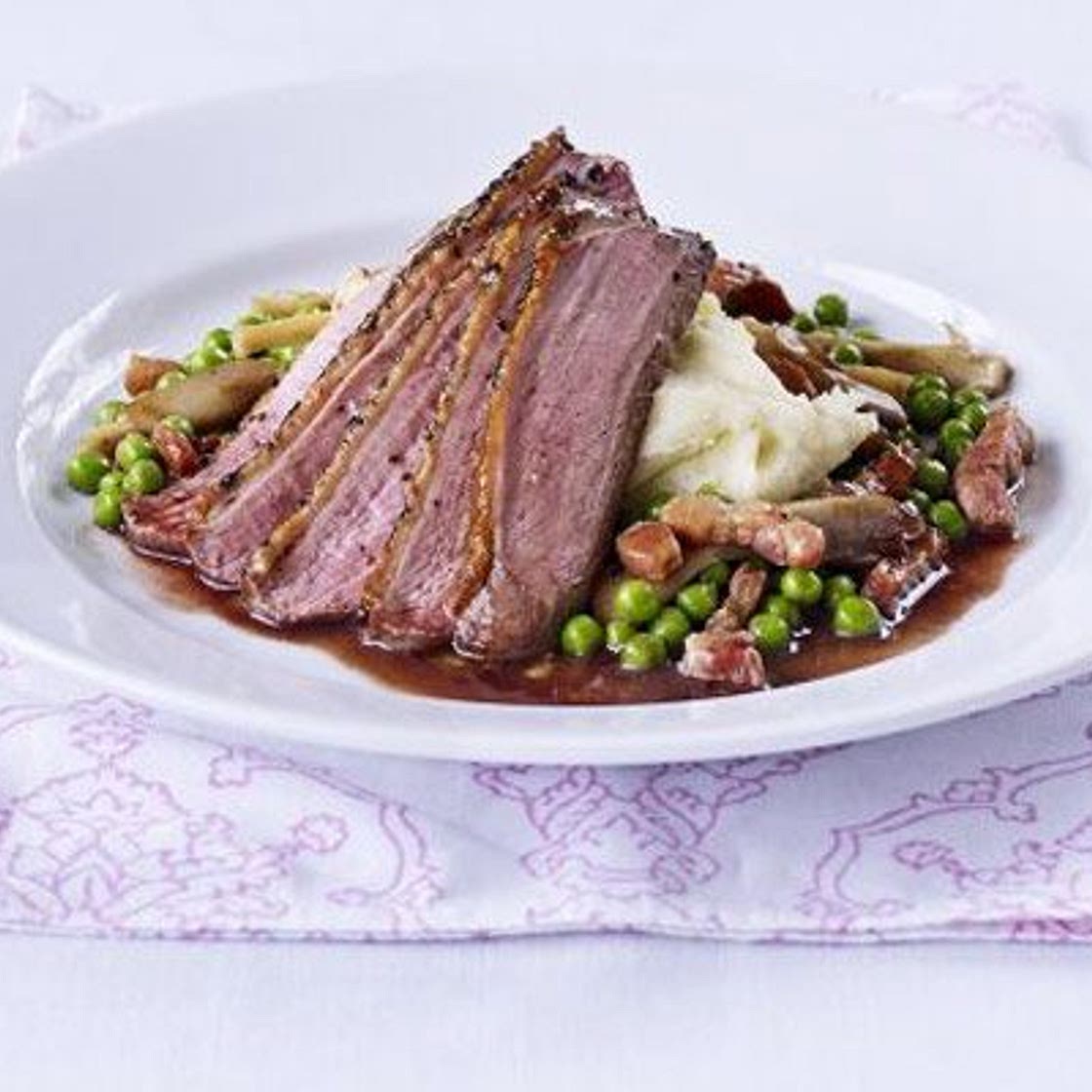 Peppered duck with vanilla mash, pea & wild mushroom ragout