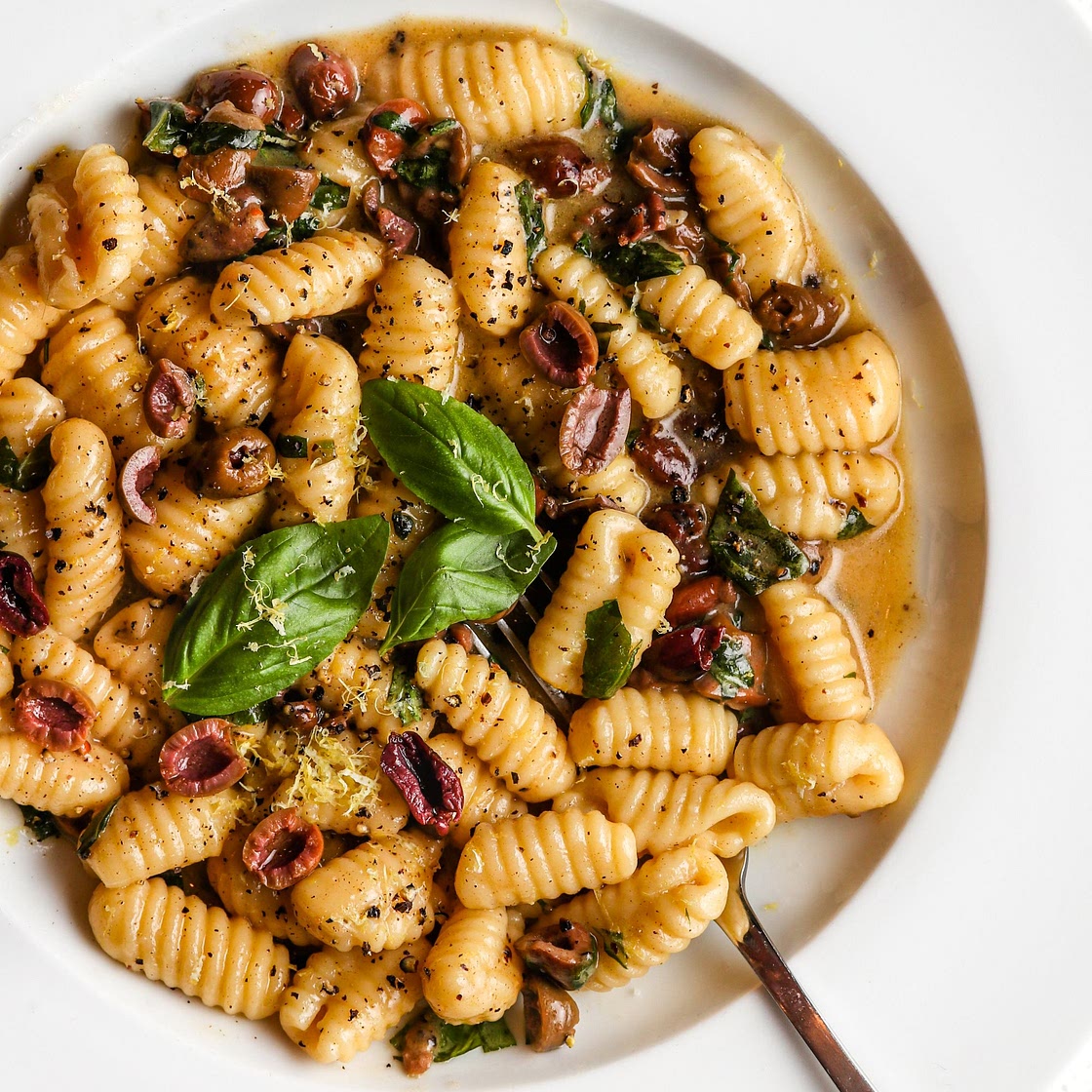 Cacio e pepe with olives and basil