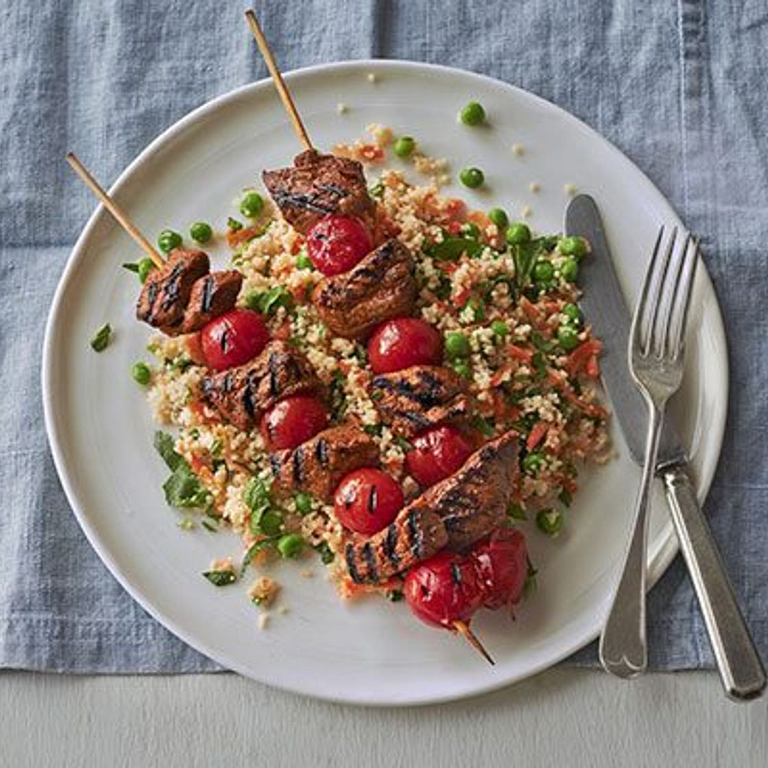 Spiced lamb kebabs with pea & herb couscous