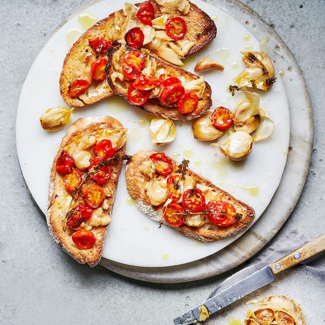 Confit garlic with roasted tomatoes on toast