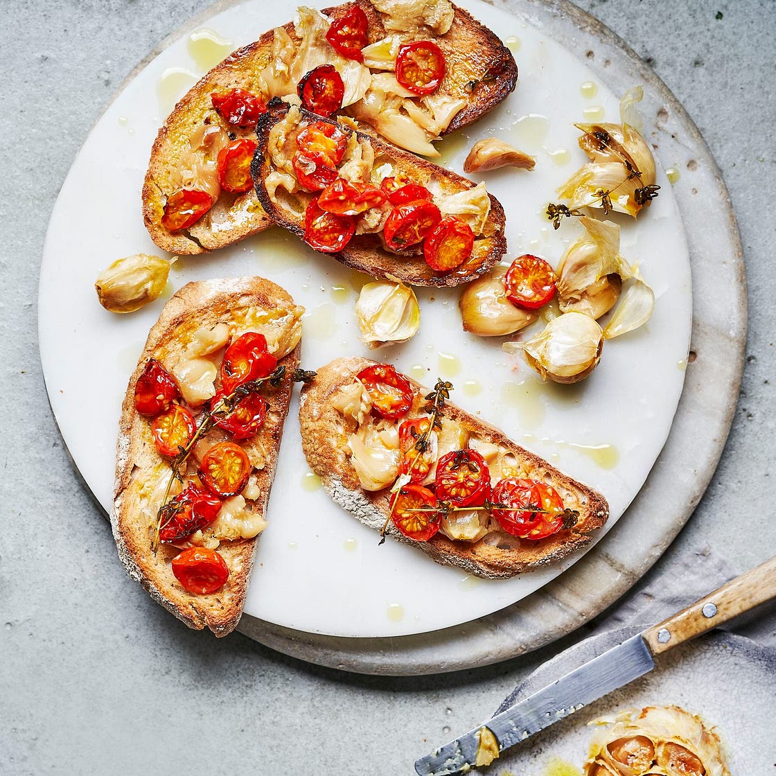 Confit garlic with roasted tomatoes on toast