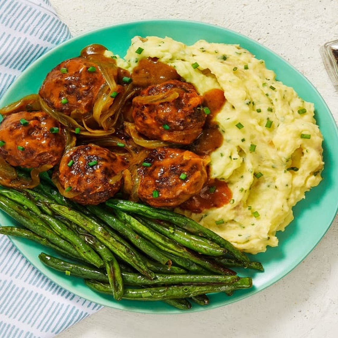 Gravy-Smothered Meatballs over Chive Mashed Potatoes with Roasted Green Beans