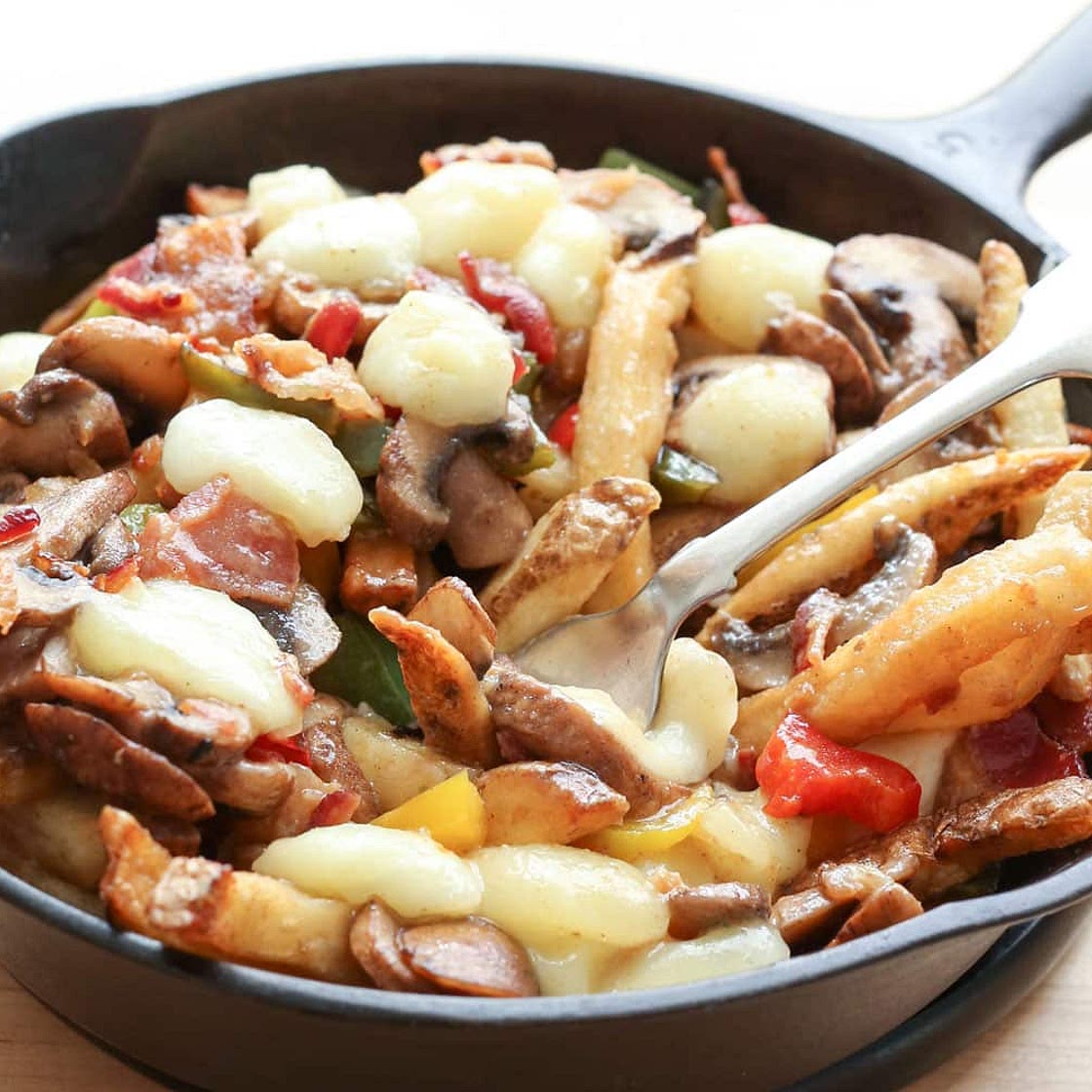 Montreal-Style Poutine with Bacon, Peppers, Mushrooms, and Onions