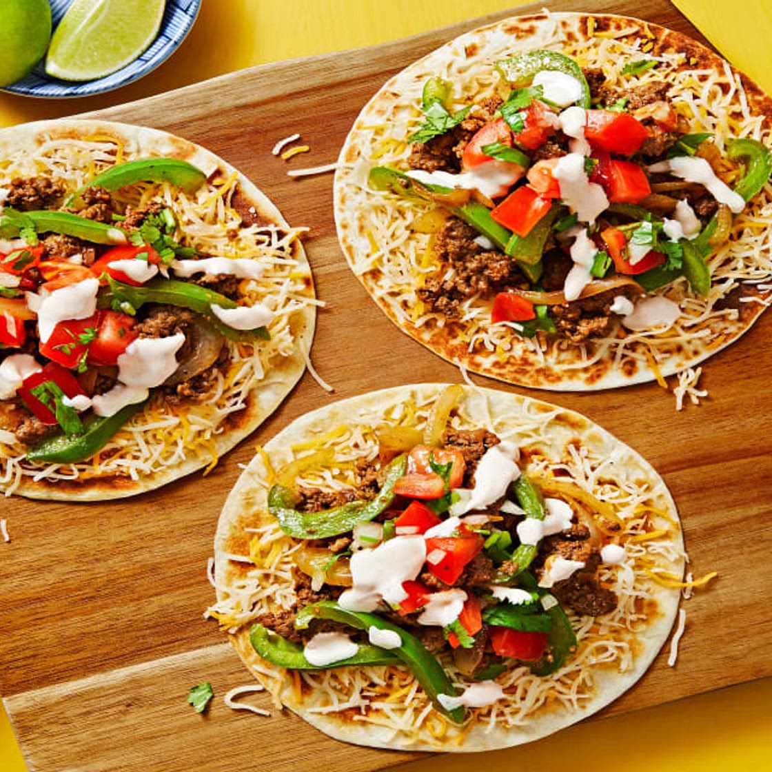 Beef & Cheese Tostadas with Green Bell Pepper, Tomato Salsa & Hot Sauce Crema