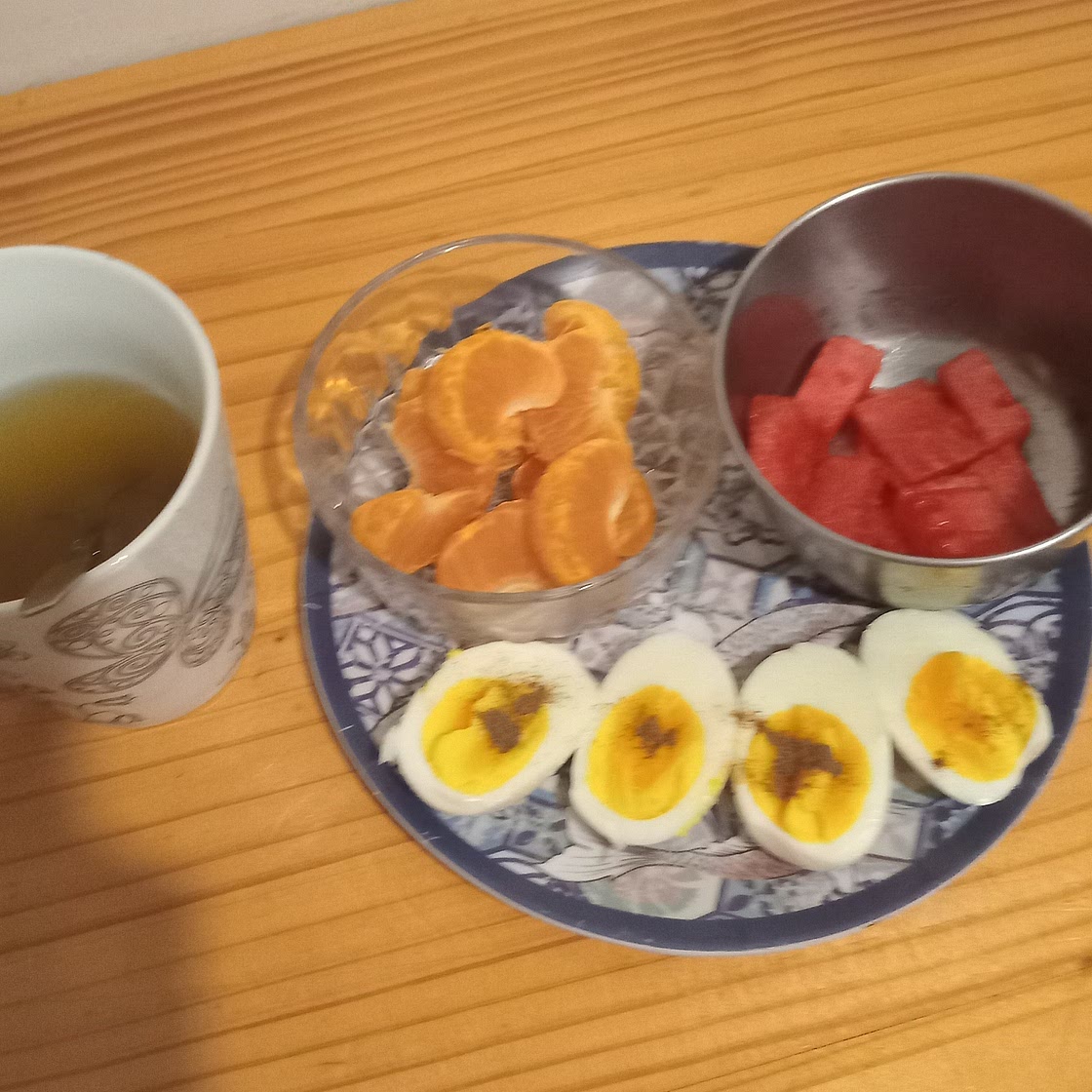 Boiled eggs with orange and watermelon