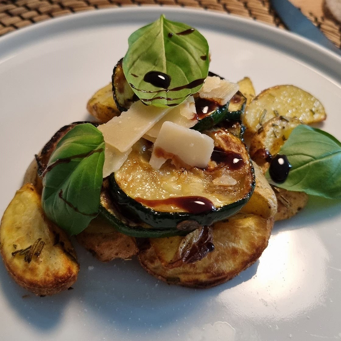 Zucchini-Pfanne mit Pinienkernen & Parmesan auf einem Rosmarienkartoffelbett