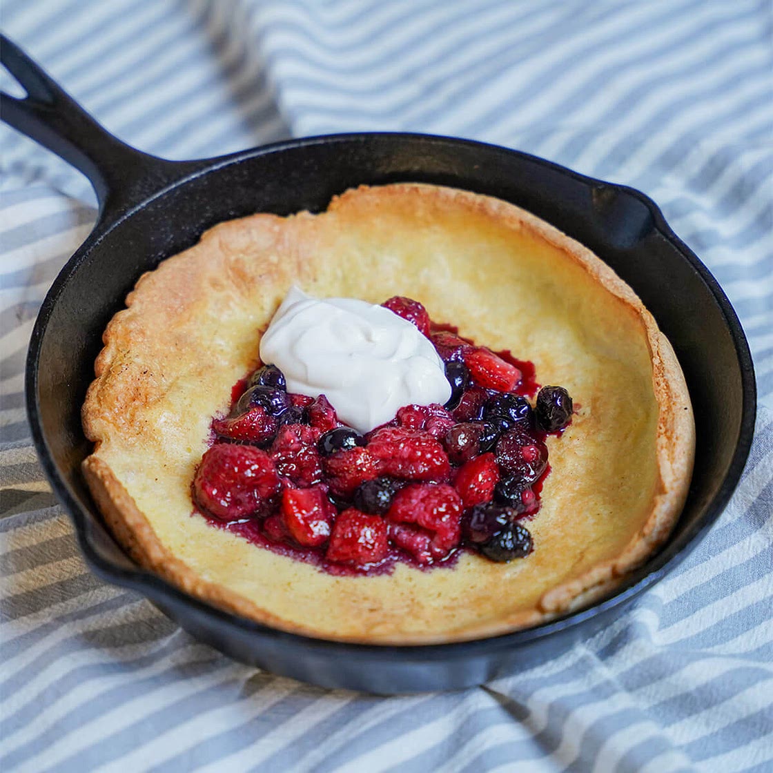 Individual Dutch baby pancake with berries and maple yogurt