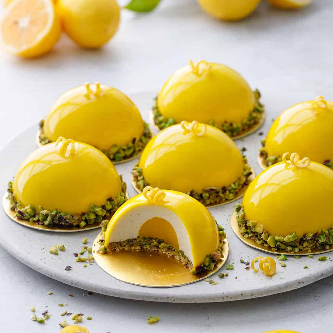 Pistachio & Meyer Lemon Mousse Cakes with Mirror Glaze
