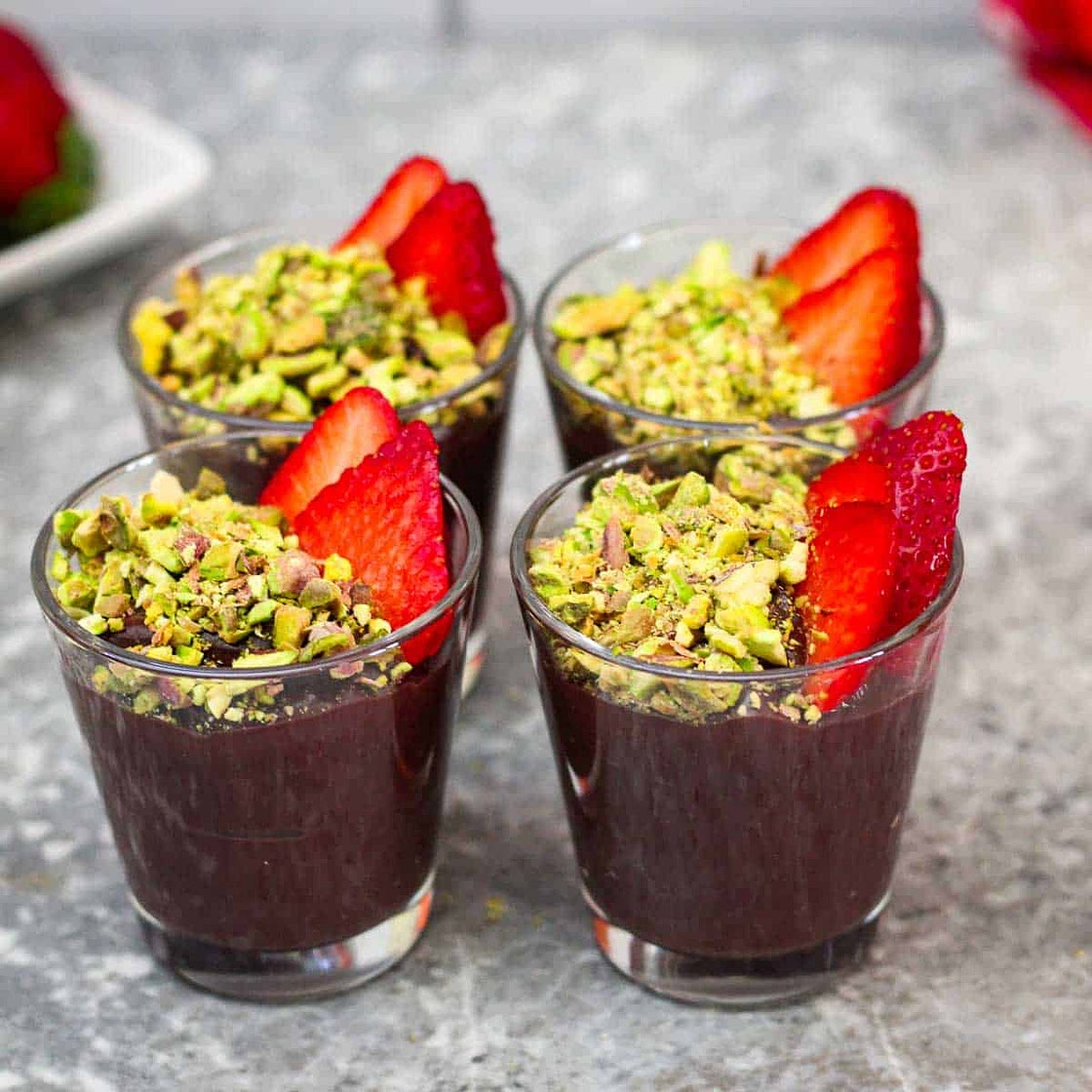 Chocolate Pudding topped with Pistachios and Strawberries
