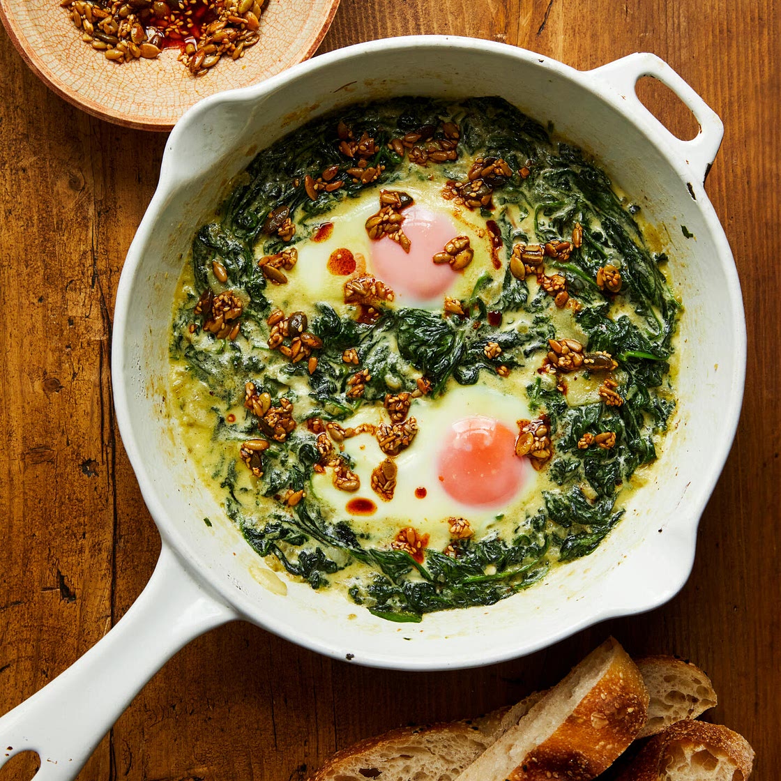 Eggs in creamed spinach with spiced butter seeds