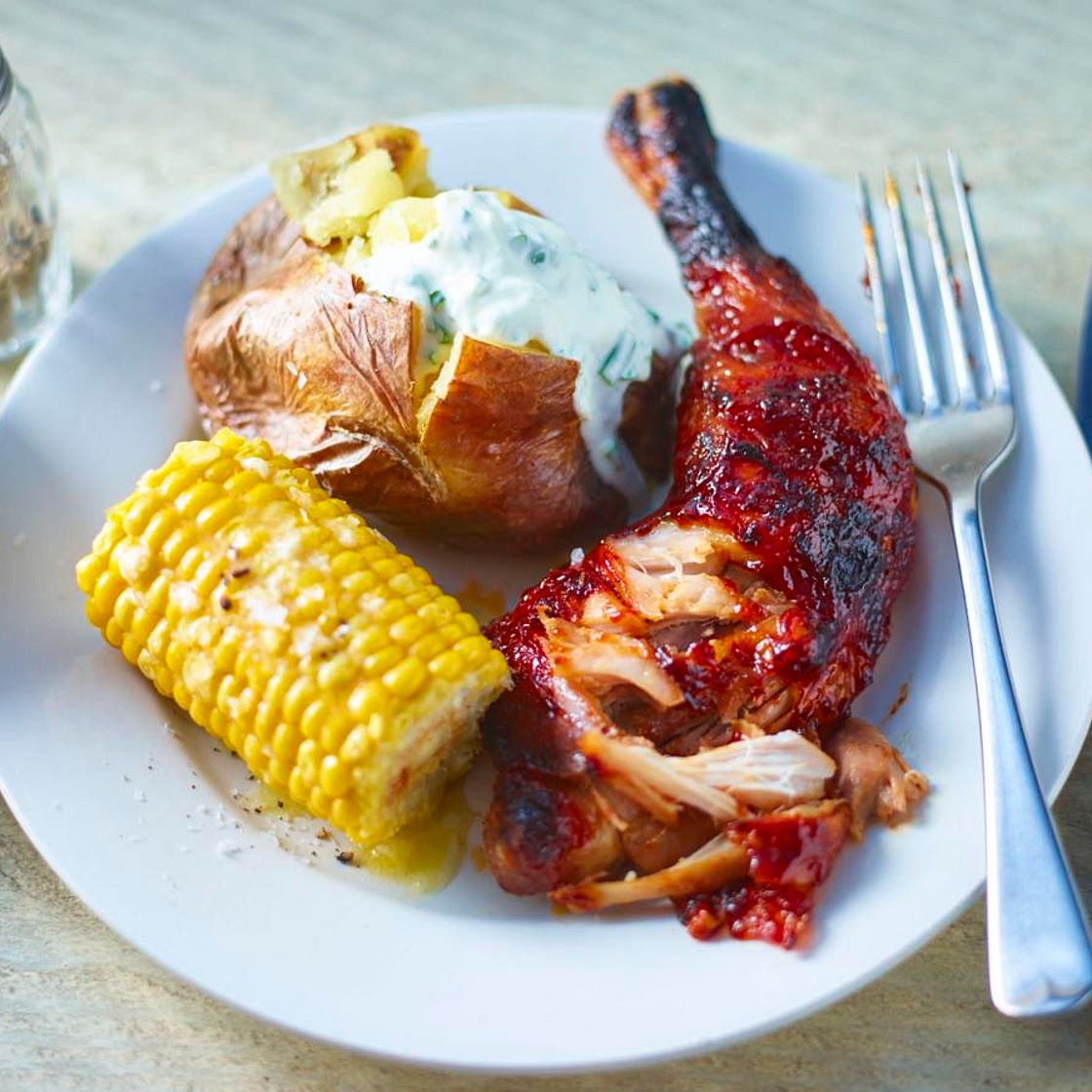 Pulled chicken with barbecue sauce and baked potatoes