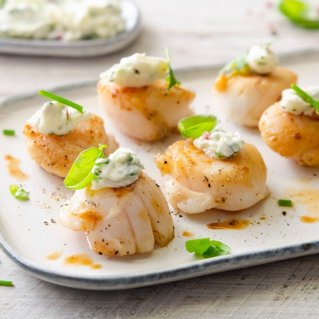 Capesante al brandy e burro alle erbe