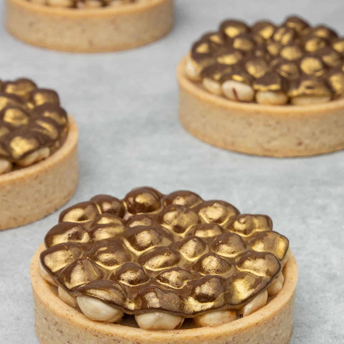 Triple Hazelnut Tart with Gold Chocolate decoration